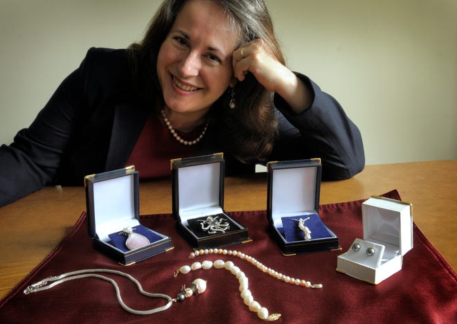 Johanna Lolax displays some of the pearl jewelry she sells at her Web-based business.