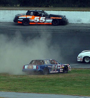 Shawn Monahan of Waterford, 55, and Paul Coutu, Jr. of Thompson , 64, spin out during a Limited Sportsman race Thursday, September 10, 2009 at Thompson Speedway.
