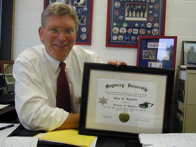 Gary Schindler, Dean of Student Affairs at Spoon River College, proudly displays his "Doctorate of Mayberry" certificate.