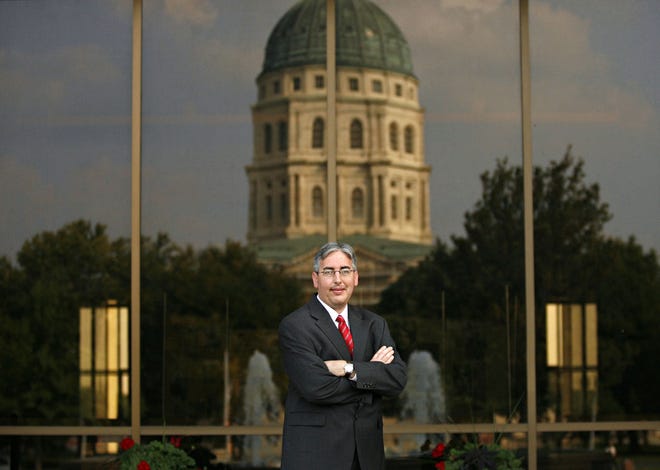 Lawyer Robert K. Collins stands in front of the Kansas Judicial Center, where he did a large portion of his research for a case against Pfizer Inc., the world’s largest drug maker. After more than six years, Blair Collins was awarded $2,354,582.