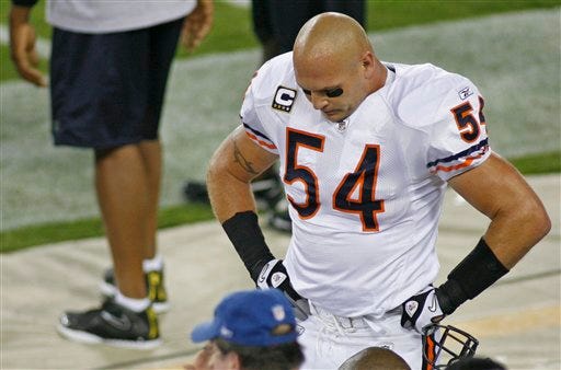 Chicago Bears' Brian Urlacher is shown on the sidelines during the first half of an NFL football game against the Green Bay Packers Sunday, Sept. 13, 2009, in Green Bay, Wis. The Chicago Tribune is reporting Bears linebacker Brian Urlacher will likely miss the rest of the season with a dislocated right wrist. In a text message sent to the newspaper Monday, Urlacher said: "season is over." (AP Photo/Jeffrey Phelps)