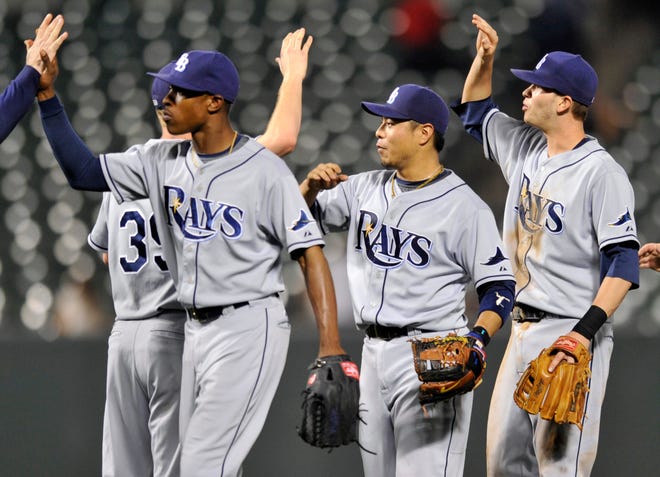 Tampa Bay Rays, left to right, B.J. Upton, Akinori Iwamura and Reid Brignac celebrate their 8-4 win over the Baltimore Orioles in a baseball game, Monday.