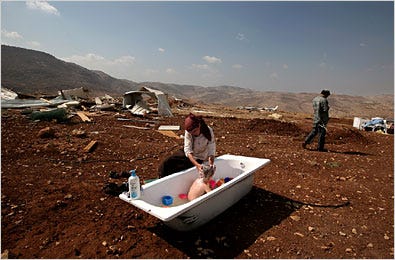 In the unauthorized West Bank outpost of Maoz Esther, a woman bathed her son. Israel has promised to dismantle such outposts.