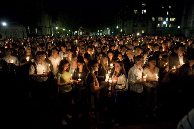 Yale University students and faculty participate in a candlelight vigil for Annie Le in New Haven, Conn. Monday Sept. 14, 2009. Clues increasingly pointed to an inside job Monday in the slaying of Le, a Yale graduate student whose body was found Sunday stuffed inside a wall five days after she vanished from a heavily secured lab building accessible only to university employees.