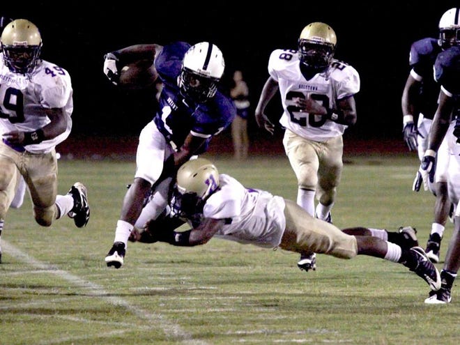 Bryant High School player Darius Williams (1) is tackled by Hueytown player Jeremy Dancy (6) during the game Friday night in Tuscaloosa.