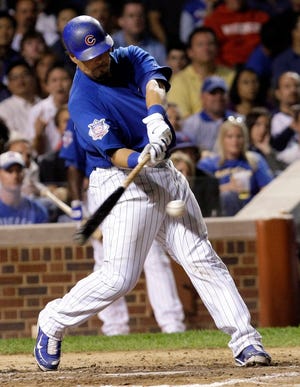 Chicago Cubs' Geovany Soto hits a two-run single off Milwaukee Brewers relief pitcher Todd Coffey, scoring Kosuke Fukudome and Derrek Lee during the sixth inning of a baseball game Tuesday, Sept. 15, 2009 at Wrigley Field in Chicago. (AP Photo/Charles Rex Arbogast)