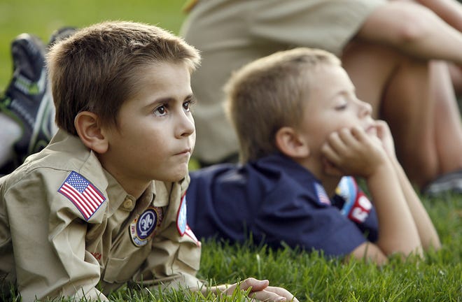 Ethan Thornton, 9, left, and Aiden Thornton, 7, listen during the kickoff ceremony to mark the 100th anniversary of Boy Scouts Wednesday at the Little Sister of the Statue of Liberty at the northwest corner of the Statehouse. Both boys are member of Troop 69, and this is their first year in Scouting.
