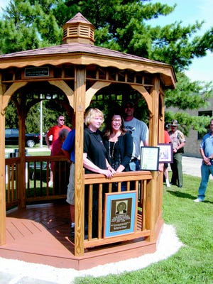 A memorial to Honorary Illinois State Police Trooper Larry “Brownie” Myers, in the form of a gazebo, was dedicated at ISP headquarters Tuesday. Pictured are his family members: wife Sharon Myers and daughter Lisa Miller, in the front row and son-in-law Jeff Miller and step-son Clint Moore, in the back row. Myers passed away in August 2008 after a battle against cancer and donations in his memory were designated to ISP for a memorial.