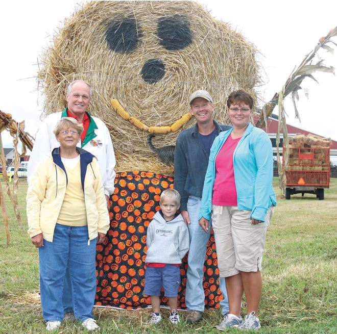 Donald E. and Verna Martin stand with their son, daughter-in-law and grandson, Donald L., Denise and Chase Martin, at the entrance to Falling Spring Farms, where the family will host the 2009 Franklin County Fall Farm Fun Fest Saturday.