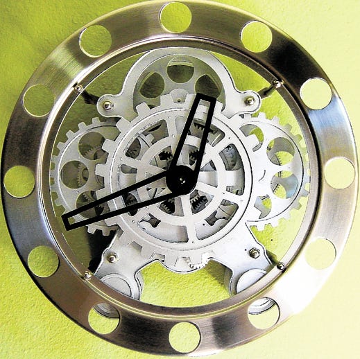 This product image released by Modern Clocks shows a Gear Clock designed by Wil Van Den Bos. Stainless steel rim houses the exposed innards of the secret workings of this ultra-cool clock. 14" in diameter. Stainless steel outer frame, plastic gears and metal hands.