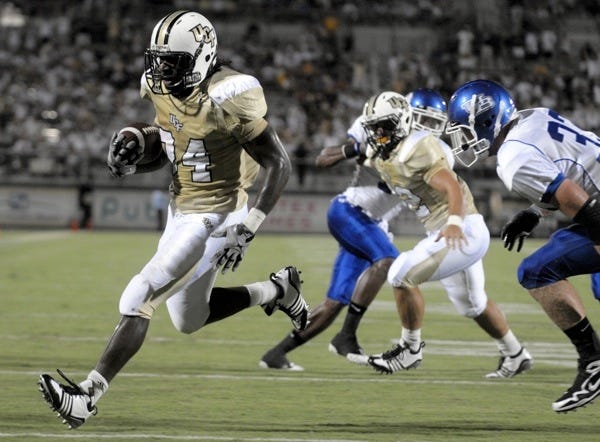 Central Florida running back Brynn Harvey, left, runs into the endzone past Buffalo linebacker Scott Pettigrew for a touchdown during the first half of an NCAA college football game in Orlando, Fla., Saturday, Sept. 19, 2009.