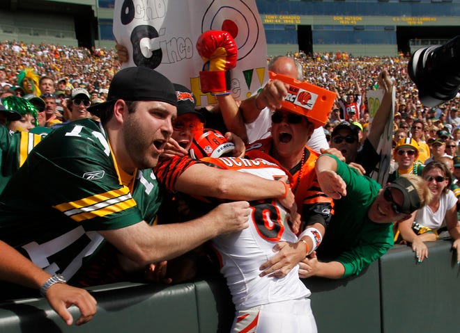 Cincinnati Bengals' Chad Ochocinco, center, jumps into the crowd after catching a touchdown pass during the second half against the Green Bay Packers on Sunday.