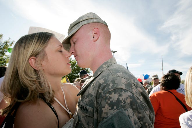 Stephanie Bickham of La Salle kisses her boyfriend, Spc. Scott Moshage of Utica, after Illinois National Guard soldiers returned from a one-year tour in Afghanistan on Saturday, Sept. 19, 2009, at the Machesney Park Armory.