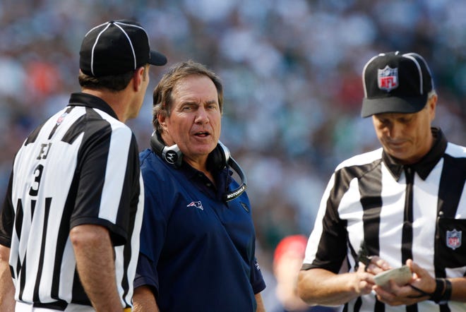 Patriots coach Bill Belichick talks with officials during the third quarter of the Pats' 16-9 loss to the Jets on Sunday in East Rutherford, N.J.