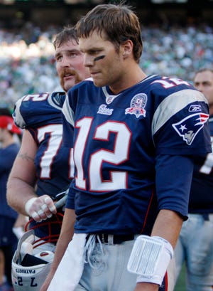 Tom Brady (12) stands next to teammate Matt Light during the fourth quarter of the Patriots' 16-9 loss to the Jets on Sunday in East Rutherford, N.J.