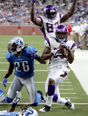 Minnesota Vikings wide receiver Percy Harvin, front, celebrates with teammate Bernard Berrian, rear, after scoring a touchdown against Detroit Lions safety Louis Delmas (26) in the fourth quarter of an NFL football game Sunday, Sept. 20, 2009 in Detroit. The Vikings defeated the Lions 27-13. (AP Photo/Duane Burleson)
