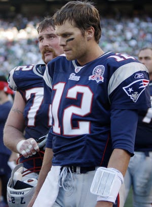 Patriots quarterback Tom Brady (12) and offensive lineman Matt Light look on late in New England's 16-9 loss to the Jets.