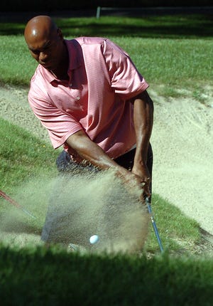 Scott Burrell, former UConn basketball star, Chicago Bulls player and now Quinnipiac University assistant basketball coach hits out of a bunker on the third hole Monday, September 21, 2009 at the Mashantucket Tribal Nation 4th annual Drive for Diabetes at the Lake of Isles golf course.