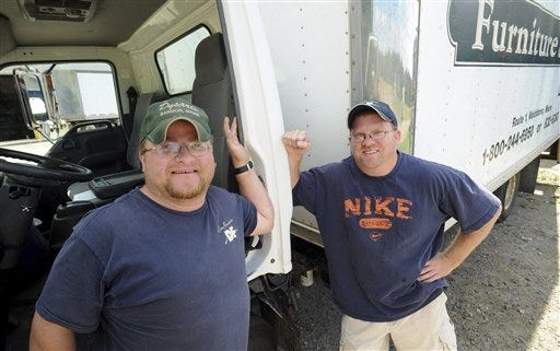 In this Sept. 17, 2009 photo, Gary Nisbet, 35, left, and Randy Joubert, 36, pose for a photo, in Waldoboro, Maine. The men who work together discovered they are brothers who were each raised by separate adoptive parents. Randy searched the state database in January to find out about his birth parents and was told that he had a brother, but he was only given a first name for his sibling. (AP Photo/The Bangor Daily News, Gabor Degre)