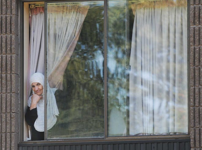 Refugee Jasmia Abdel Karime looks out the window of her room at the former Northbridge Nursing Home.