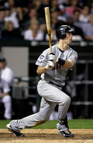 Minnesota Twins catcher Joe Mauer follows through on a double off Chicago White Sox starting pitcher John Danks that scored Orlando Cabrera during the fifth inning Tuesday, Sept. 22, 2009, in Chicago.