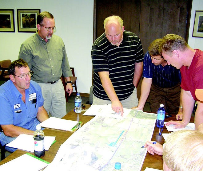 Roadmaster Paul Minnich, left, explained concerns he has with the pending intermodal railway facility planned for Antrim Township. Looking over a map of the project are administrator Brad Graham and supervisors James Byers, Fred Young III and Samuel Miller.