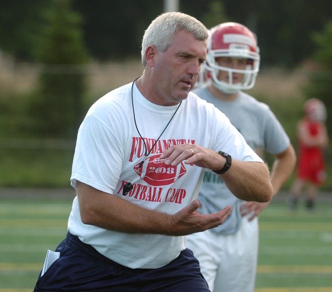 B-R head coach Dan Buron, works with the running backs on how to hold the football.