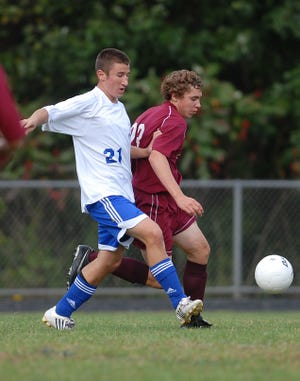 COLCHESTER 9/23/2009
Bacon's Jim Nickerson, left, kicks the ball away from East Lyme's Zach Skelton, right, during a soccer game at Bacon Academy in Colchester Wednesday, September 23, 2009.
Tali Greener/Norwich Bulletin