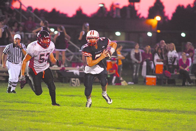 United's Sheldon Welch chases down West Central's Dylan Bell in the season opener for both teams.