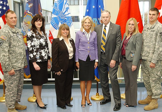 FAMILY MEMBERS AND SOLDIERS of the 206th Military Police Company, headquartered in Latham, pose with Dr. Jill Biden at the New York National Guard headquarters on Monday. From left are Army Sgt. Derreck Venne; Theresa Martel, wife of Army 1st Sgt. Joseph Martel; Mary Lou Herringshaw, wife of Army Sgt. 1st Class Frederick Herringshaw; Biden; Gordon Lattey; Kim Manion, wife of Army Capt. Kevin Manion; and Army 2nd Lt. Stephen Groene. Herringshaw, a resident of the town of Danube, was selected to the attend the meeting due to her involvement with the 107th Military Police Company’s Family Readiness Group.