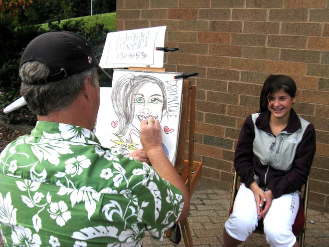 Dominique Lyons, 13, of Cazenovia, poses for artist W.C. Pope of Herkimer as he draws her caricature during the SUNY Institute of Technology annual Fall Fest parent-family weekend on campus Saturday, Sept. 26, 2009, in Utica.