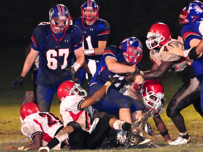 Southern Choctaw players tackle Zach Smithson (3) of American Christian Academy during the second half of the football game at ACA Friday night.