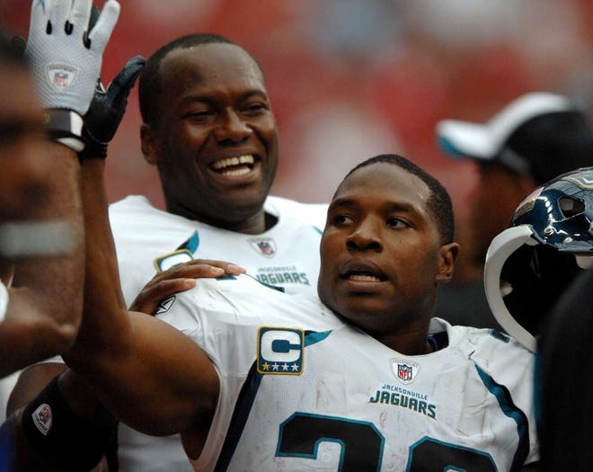 Jaguars running back Maurice Jones-Drew (front) receives congratulations from quarterback David Garrard after Drew's 61-yard touchdown run against the Houston Texans on Sunday. (RICK WILSON/The Times-Union)