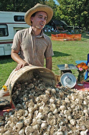 Dan Kittredge with a bushel of organic garlic from his Barre farm. Of course, the event is as noted for artwork as it is for the garlic.