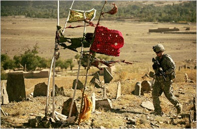 An American soldier walked through a cemetery during an investigation into a rocket attack on a combat outpost in the Jalrez Valley in Wardak Province.