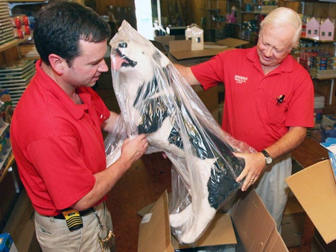 Rich Anders, left, and his father Rodger unpack a life-sized toy dog in the Anders Hardware Toy Shoppe seen here Thursday September 24, 2009 in Northport.