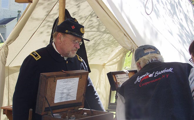 CARL SAHRE OF HERKIMER mans the Civil War medical tent at German Flatts Town Park during the eleventh annual Living History Weekend.