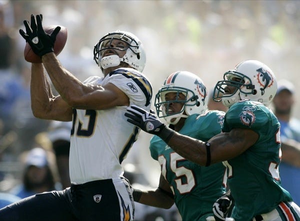 San Diego Chargers wide receiver Vincent Jackson, left, hauls in a pass over Miami Dolphins safety Yeremiah Bell, right, and cornerback Will Allen, center, in the second half of an NFL football game Sunday, Sept. 27, 2009, in San Diego. (AP Photo/Chris Park)