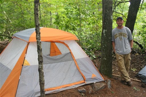 William Hawkins, a convicted sex offender, leans on a tree next to his tent in an encampment of sex offenders in a wooded area of Marietta, Ga. on Sept. 23, 2009. Nine people on the sex offender registry live in the camp, saying Georgia's strict sex offender law has left them few options. The law bans sex offenders from living, working or loitering within 1,000 feet of schools, churches parks and other spots where children gather.