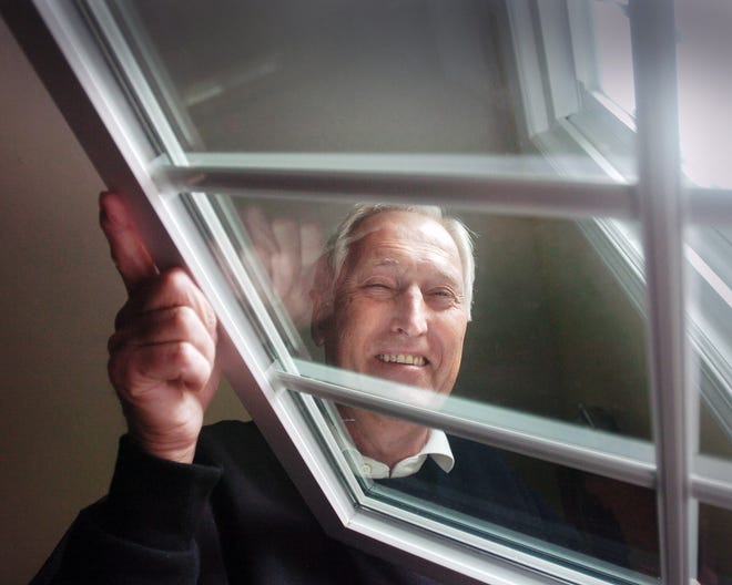 Arnie Gabrielle admires the new double-paned, triple-glazed, energy efficient windows he had installed in his home. By installing the windows, he qualifies for a $1,500 tax credit this year.

photo: Amelia Kunhardt
story: Steve Adams