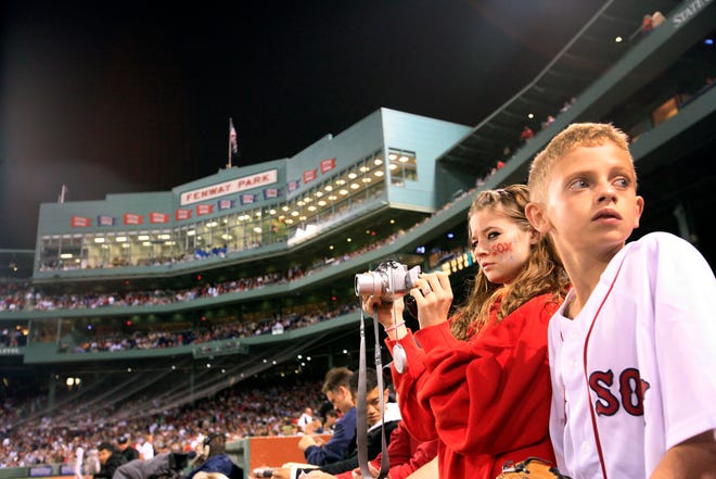 Wide-eyed Alexis Villegas,16, and her brother David of West Roxbury take in the sights of Fenway Park in Boston.