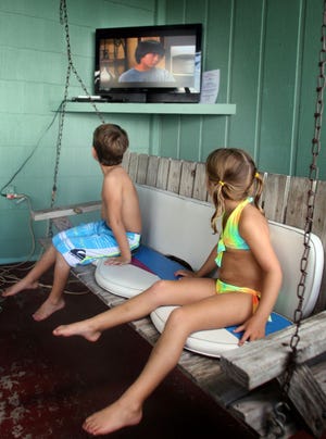 Allison Kay, 5, and her 5-year-old brother, Aaron, enjoy an episode of “The Chefsters” on Sept. 20 in Ocklawaha.