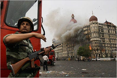 An Indian soldier took cover as the Taj Mahal hotel burned during a gun battle between Indian military and militants inside the hotel in Mumbai in November 2008.