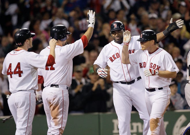 From left, Boston's Jason Bay (44), Casey Kotchman (11) and David Ortiz celebrate with J.D. Drew, far right, after Drew hit a three-run homer in the eighth inning against the Toronto Blue Jays on Tuesday, Sept. 29, 2009.