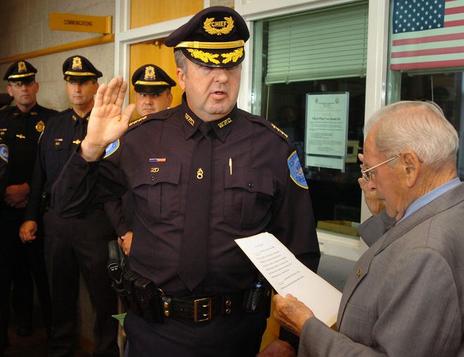 Weymouth Police Chief Richard Grimes was sworn in at the Weymouth Police Station lobby this morning. Town Clerk Franklin Fryer swears him in.