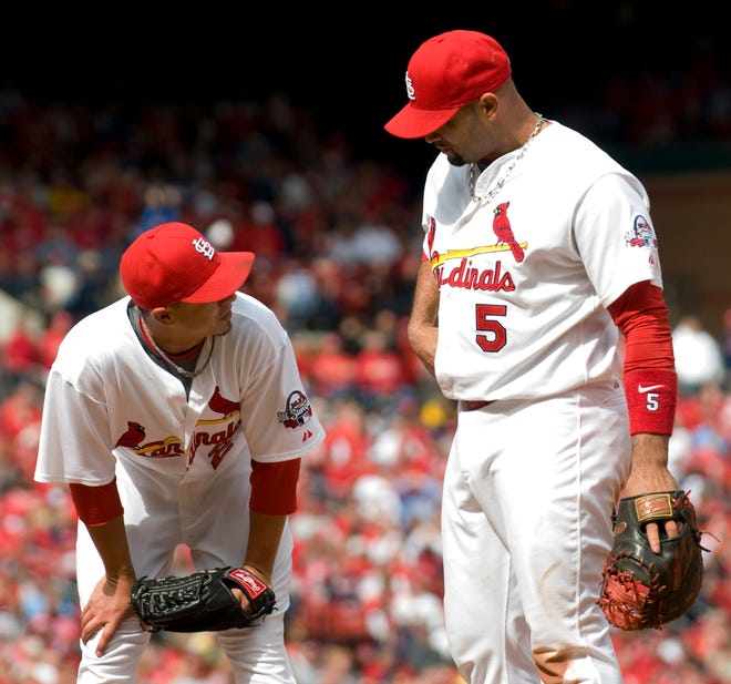 Cardinals first baseman Albert Pujols (5) talks with pitcher Kyle Lohse after the Brewers scored two runs on a throwing error by second baseman Julio Lugo during the sixth inning on Saturday in St. Louis. Milwaukee won, 5-4.