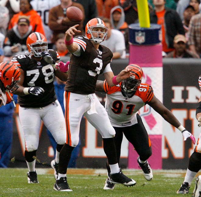 Derek Anderson throws a pass in the OT period after getting pressure from the Bengals Robert Geathers.