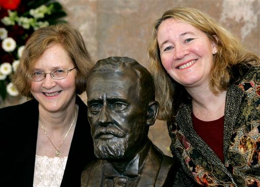 In this file photo of Saturday, March 14, 2009 U.S. biologists Elizabeth H. Blackburn from San Francisco, left, and Carol Greider from Baltimore pose next to a bust of Paul Ehrlich before they were awarded the Paul Ehrlich and Ludwig Darmstaedter science prize in Frankfurt, Germany. On Monday Oct. 5, 2009 Sweden's Karolinska institute gave the 2009 Nobel Prize in medicine to Americans Elizabeth Blackburn, Carol Greider and Jack Szostak. The institute says the trio was awarded "for the discovery of how chromosomes are protected by telomeres and the enzyme telomerase."
