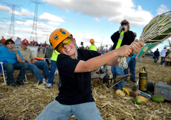 Twelve-year-old Taylor Miller of Herrick bears down as he prepares to launch his pumpkin with his fellow Boy Scouts from Troop 98 during 2008's Punkin Chuckin' Contest at the Uhlman Family Farm in Morton.