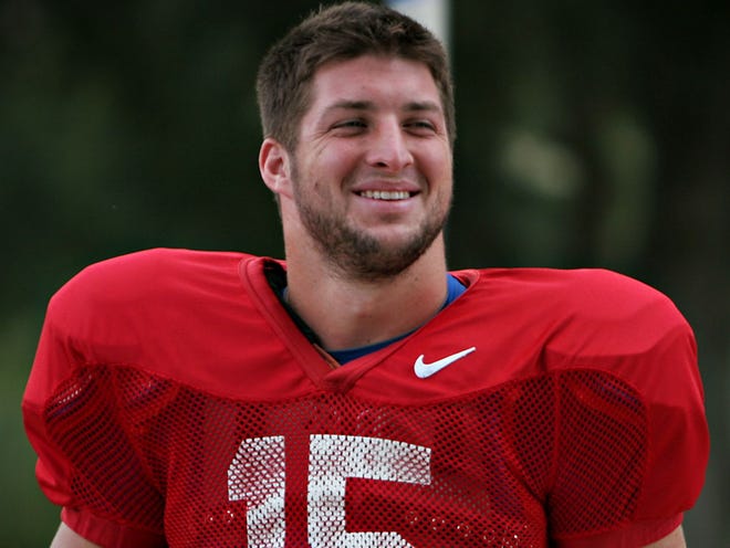 Florida quarterback Tim Tebow smiles as he walks toward the practice field outside of the University of Florida's Ben Hill Griffin Stadium on Oct. 7, 2009.